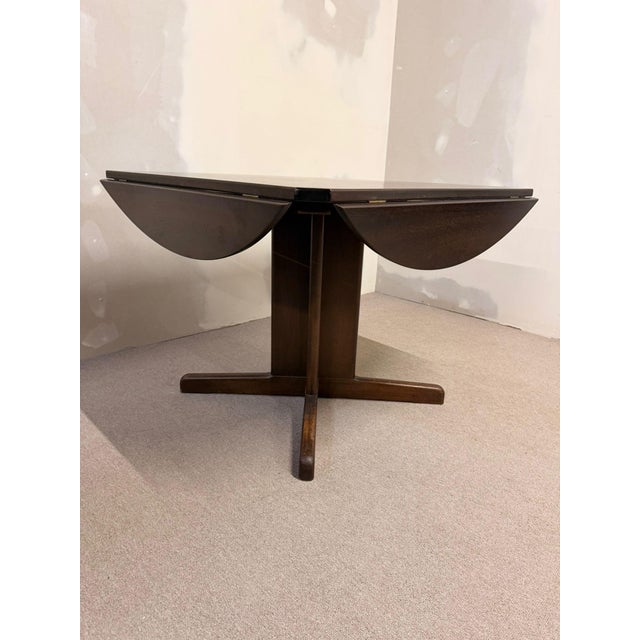 A Danish mid-century dining table from the 1960s that can be easily transformed from a square to a round table. A true...