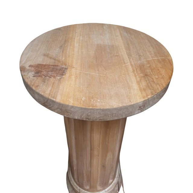 A handsome architectural pedestal crafted of wood with a beautifully aged, natural finish. The tall column features...