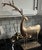 This substantial metal deer sculpture showcases hand-forged craftsmanship, most notably in the twisted antlers, which...