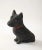 Unique reconstituted stone garden statue in the shape of a black painted Scottie dog with red paint collar, and amber...