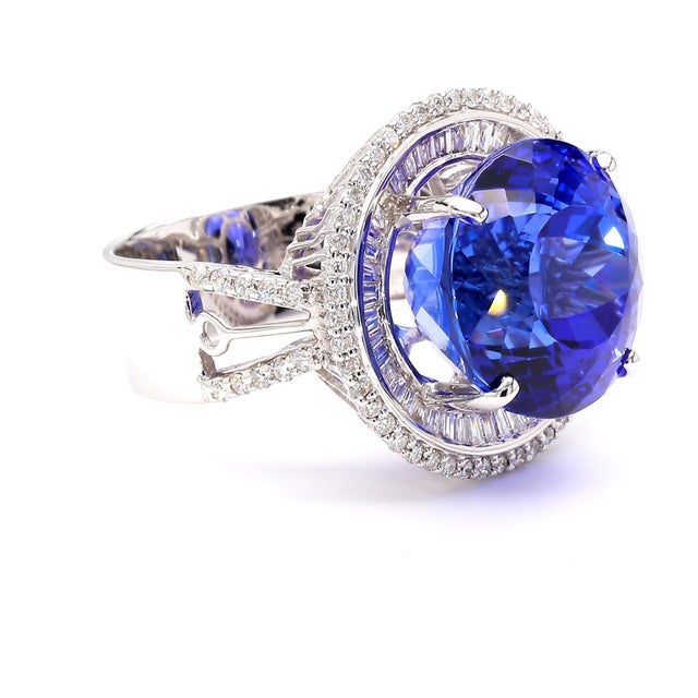 A 15.50 carat round cut tanzanite and 1.50 carat total weight diamond double halo cocktail ring in 14K white gold,...