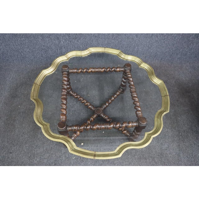 Mid Century coffee table with mahogany barley twist base and brass/glass scalloped edge top.