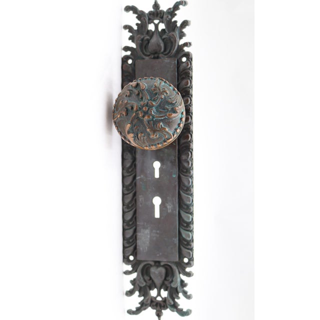 Vernacular style entry door knob set made of bronze with a dark patina. It was in the 1890 catalog. Part of the E-12600...