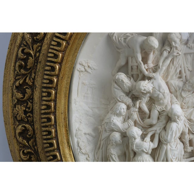 This evocative 19th‑century Belgian bas-relief in pipe clay under rounded glass with gilt frame by E. Cassier pays homage...