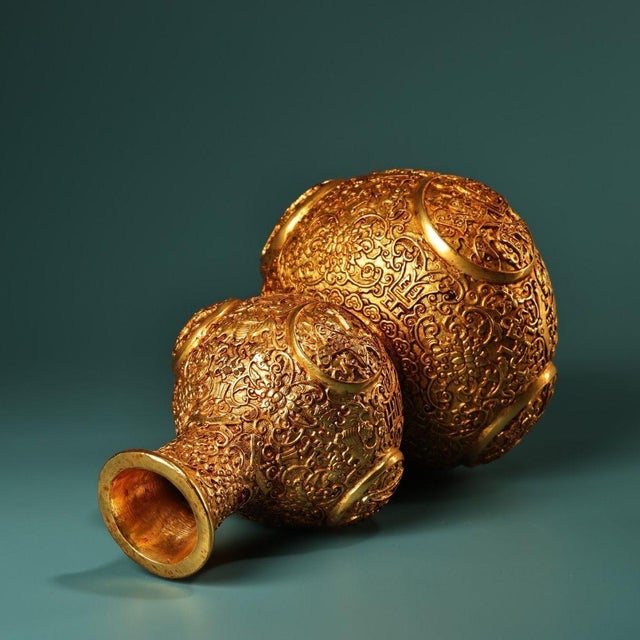 A breathtaking and highly ornate vintage vase, masterfully cast in bronze and finished with a radiant gold-gilt. Standing...