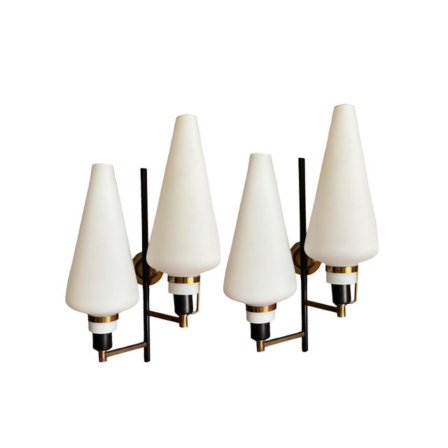 Pair of large Italian wall lights from the 1950s, featuring elegant opaline glass shades, black lacquered brass arms and...