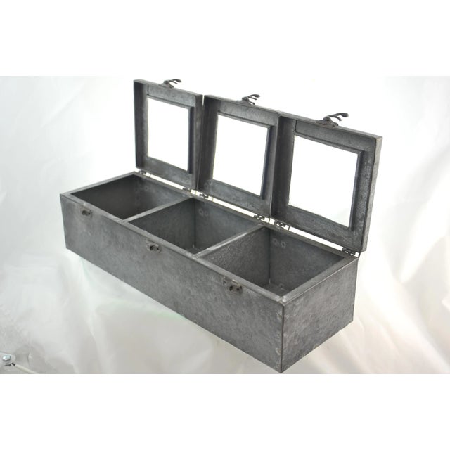 Large 16 inch zinc curio box with three glass window display or storage compartments as well as brass swing latch hinges....