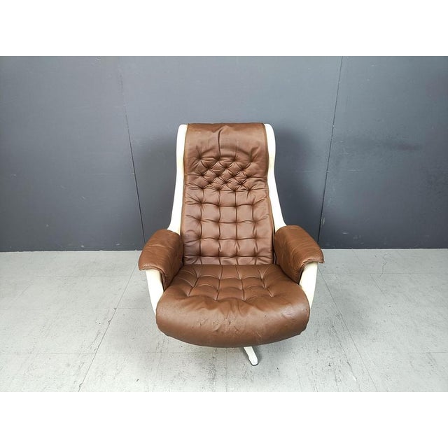 Vintage Space Swivel Armchair by Alf Svensson & Yngve Sandström for Dux, 1970s Plastic shell, aluminum base and brown...