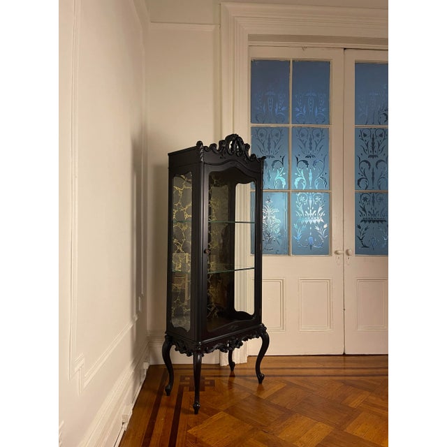 1960's Vintage Vitrine in the French Louis XV style painted matte black for a contemporary minimal aesthetic, this piece...