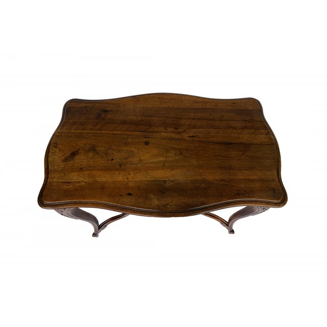 A fine 19th century Provincial French Louis XV style center table. The table is raised on carbiole legs topped with...