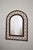 Rattan arch mirror, 1970s. Arch-top mirror with an open diamond lattice rattan frame and wrapped cane bindings, in a warm...