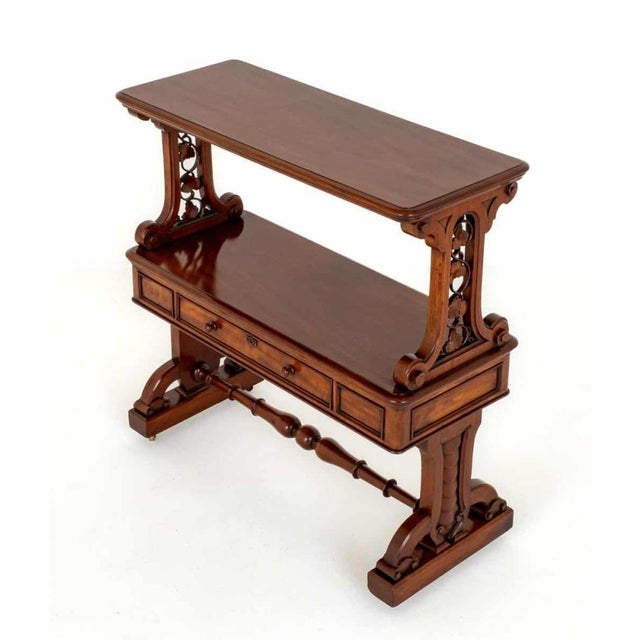 This Victorian dumb waiter features 1 mahogany lined drawer and has rather unusual end supports Great piece as a bookcase...