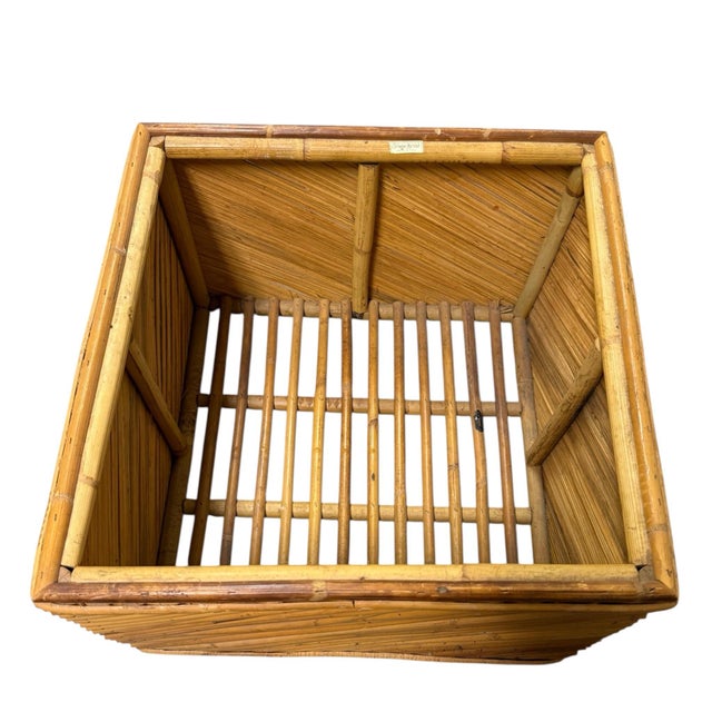 Stylish storage basket made of rattan and bamboo. Diagonal patterned sides and slat bottom, perfect for towels or paper...