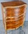 Elegant satinwood makes up this ornate chest on chest from France in the early 20th Century. Wood trim painted gold adds...