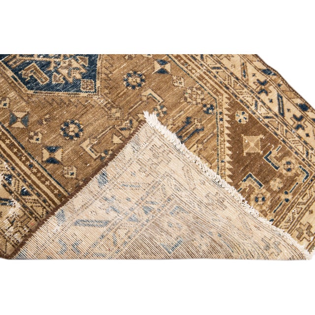 Beautiful Vintage Tribal hand-knotted wool rug with a blue field. This rug has brown and tan accents all-over a geometric...
