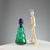 Green glass bottle with blue cap. Designer's signature. Bottle height 26 cm. Original box. This piece is attributed to the...