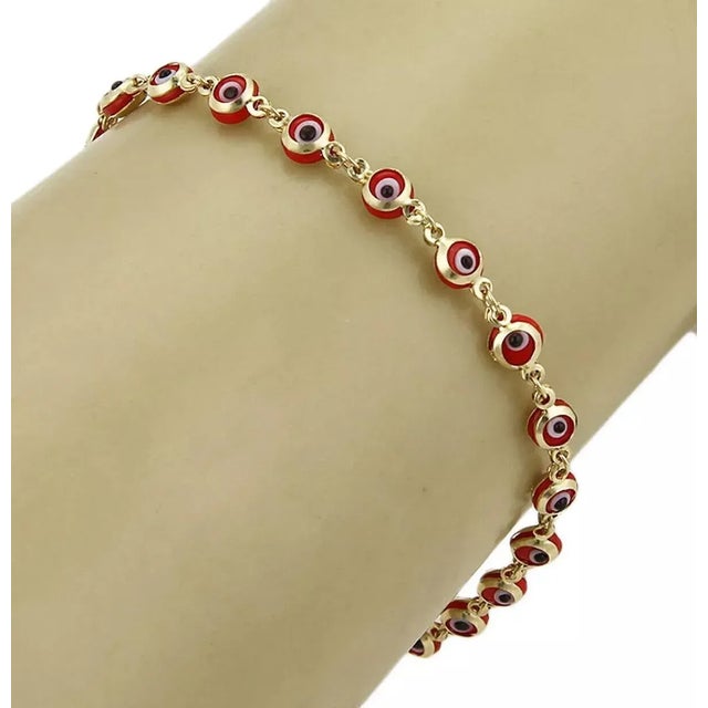 Material: 14k yellow gold Measurement: 7.25" long x 4mm wide x 3mm high Weight: 2.7 grams This evil eye bracelet is...