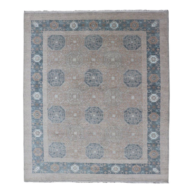 Modern Hand Knotted Khotan in Wool With All-Over Medallion Design in Blue and Earthy Tones For Sale