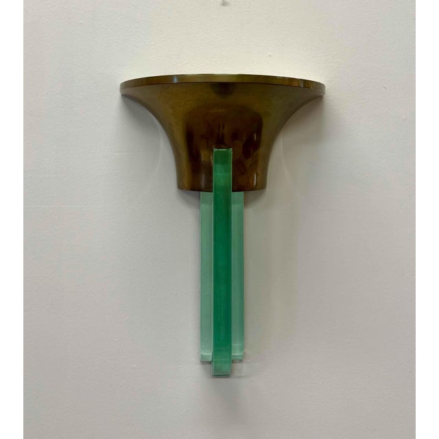 Elegant French wall sconce from the 1940s, attributed to the renowned designer Jean Perzel. Made of brass and frosted...