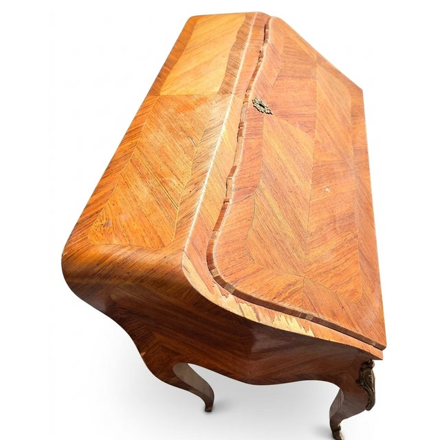 This piece is an authentic 18th-century French lady’s writing desk, specifically identified as a Louis XV Gilt-Bronze...