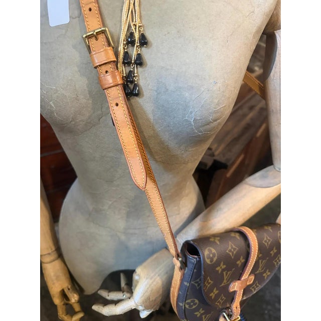 This Louis Vuitton Chantilly crossbody bag is a timeless house classic, featuring a distinctive rounded saddle silhouette...