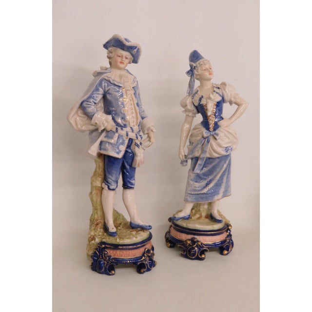This gorgeous Pair of 2 Figurines is made of porcelain with a glossy finish. These beautiful pieces present a primarily...