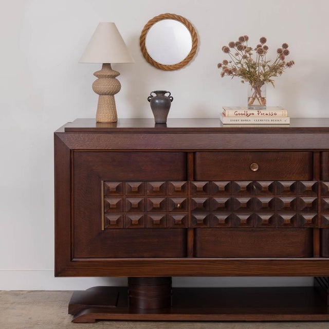 Stunning oak sideboard by Charles Dudouyt from France, 1940s. Intricately carved wood square detail on cabinet doors and...
