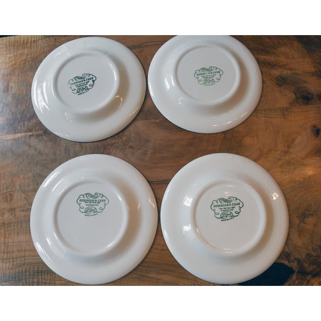 A set of four vintage Currier & Ives dinner plates featuring The Old Grist Mill from the Currier & Ives collection...