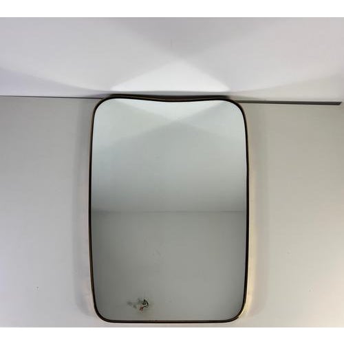 Vintage Italian wall mirror from the 1960s, crafted entirely from brass and attributed to Gio Ponti. The mirror is...
