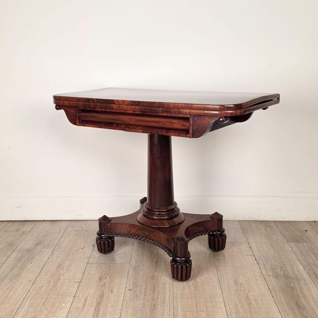 A late Regency period pedestal game table, England circa 1825. Measures 29.5" h x 36.25" w x 18" d when closed; 28.5" h x...
