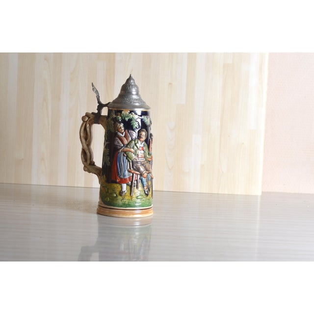 This traditional German ceramic beer stein embodies the classic craftsmanship of the region. It is distinguished by its...