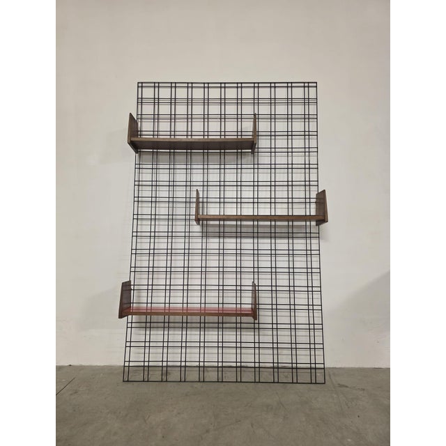 Gio ponti bookcase for studio pfr rare modular wall bookcase. black lacquered metal rod frame. three veneered wood...