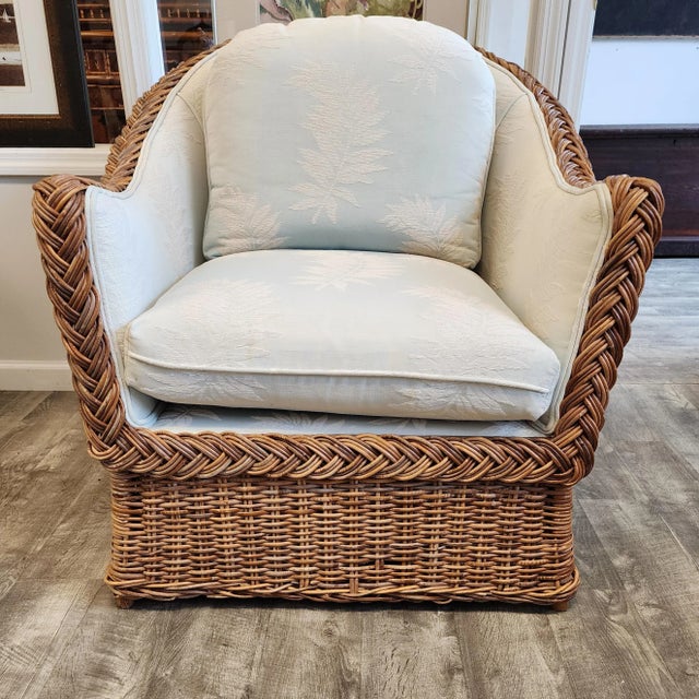 Charming wicker rattan armchair in a warm caramel color made in the coastal organic manner and style of Michael Taylor....