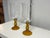 Design Plus Gallery presents a Pair of Glass Pedestal Hurricane Candleholders. Each candleholder has a clear glass bowl...