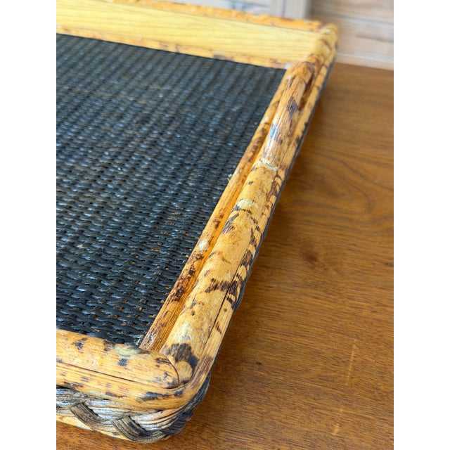 A wonderfully rustic vintage serving tray crafted with scorched bamboo, woven rattan and raised loop handles. The dark...