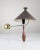 A 1950s wall sconce featuring an elegant, precision-turned, solid wood handle finished in a stylized teardrop shape. The...