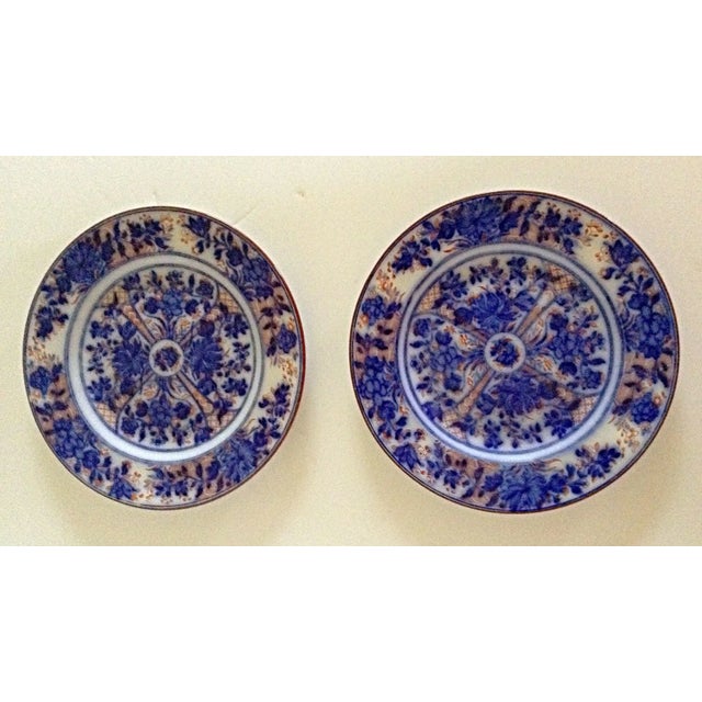 Unusual pair of flow blue Wedgwood plates have the added color of red throughout the design and on the outer rim.