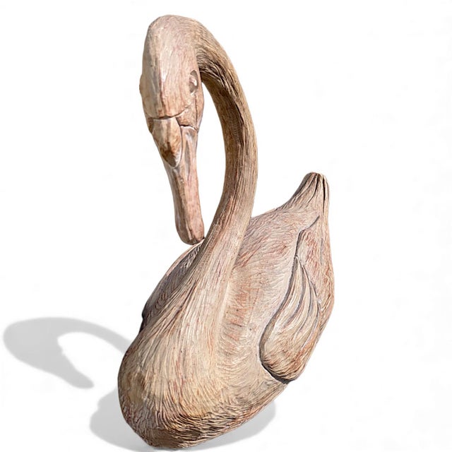 A large heavy faux bois polyresin swan sculpture. The swan at first glance appears to be carved of wood due to its...