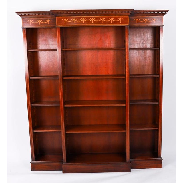 This is a delightful vintage open bookcase in the Sheraton style, dating from the late 20th Century. This breakfront open...