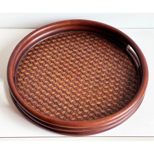 This round Japanese bamboo tray features an intricately woven base with a mesmerizing cube illusion pattern, executed in...