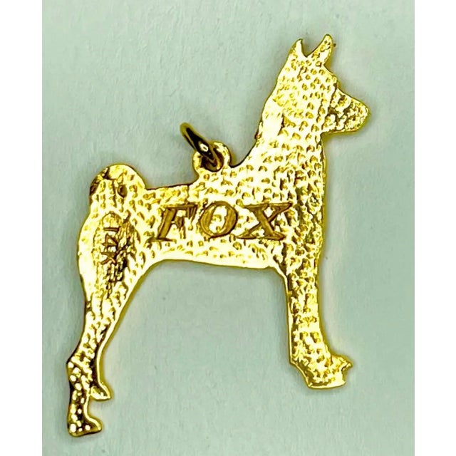 A charming vintage fox terrier pendant or bracelet charm crafted in solid 14K yellow gold. Depicted standing in profile,...