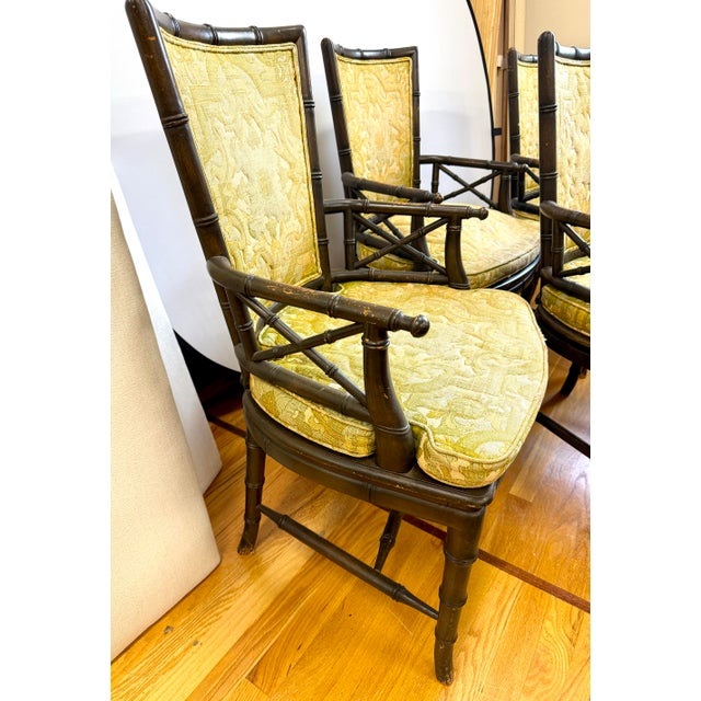 Set of 4 vintage faux bamboo dining chairs feature Chinoiserie-inspired frames and fretwork. The seats are caned with...