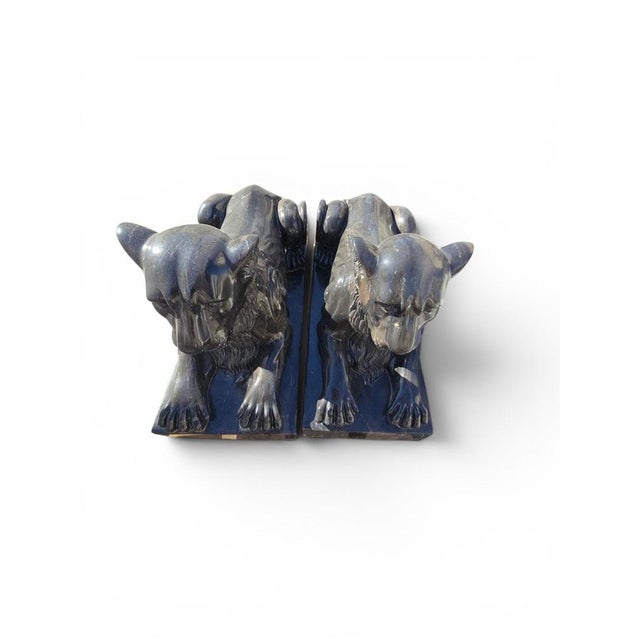 Elegant pair of lion sculptures carved from black marble in Italy during the second half of the 20th century. Inspired by...