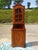 Small, tall, and narrow corner cabinet composed of two parts: a corner sideboard with one cupboard door topped by a...