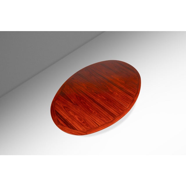 Constructed from premium solid and veneered Brazilian rosewood, this extension dining table boasts a durable and high-...