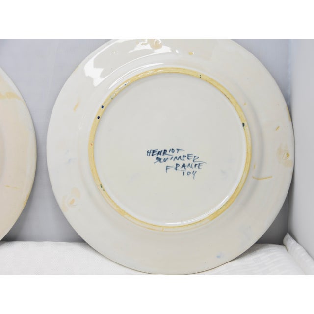 Add a touch of French charm to your home with this delightful set of two Henriot Quimper faience plates. Each plate...