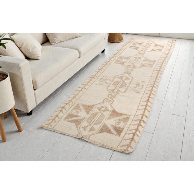 This is a vintage Turkish Oushak rug from the Mid 20th Century. The piece was hand-knotted.