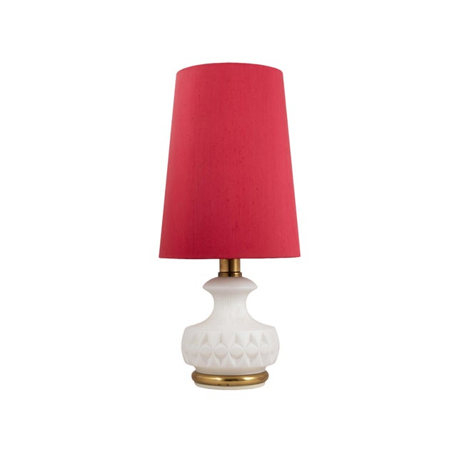 A stunning Peill & Putzler design! This lamp has a milk glass base, and the original raspberry red lampshade. The lamp has...
