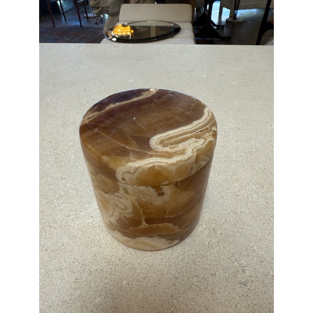 Beautiful cylindrical lidded box hand-carved from natural marble, crafted in Italy in the 1970s. The stone displays warm...