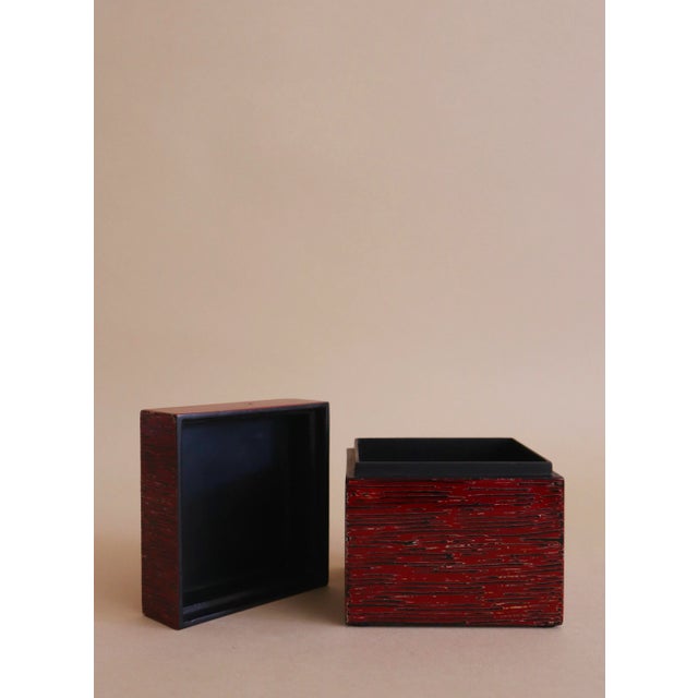 Small red lacquer box with attractive bamboo pattern highlighted in black and gold. Colorful exterior with black interior...